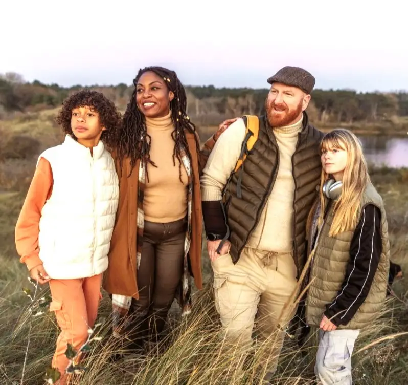 A mixed race melded family enjoying life whilst grounding in nature in an autumn park in the Netherlands
